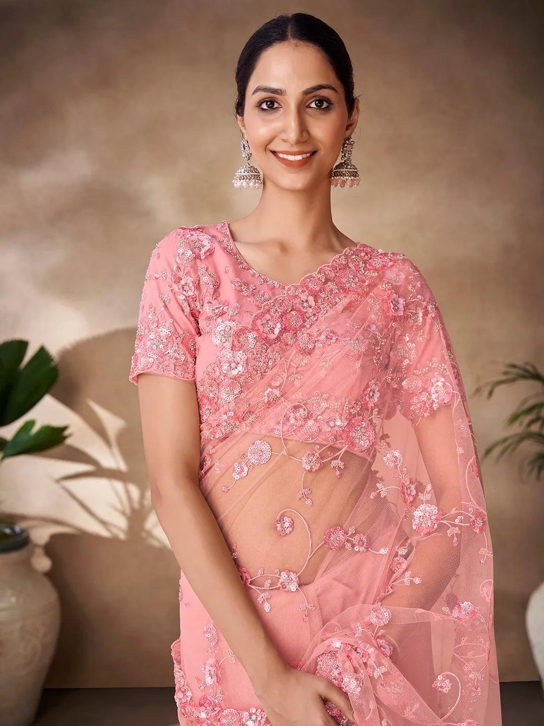Peach color net base zarkan, thread and embroidered saree