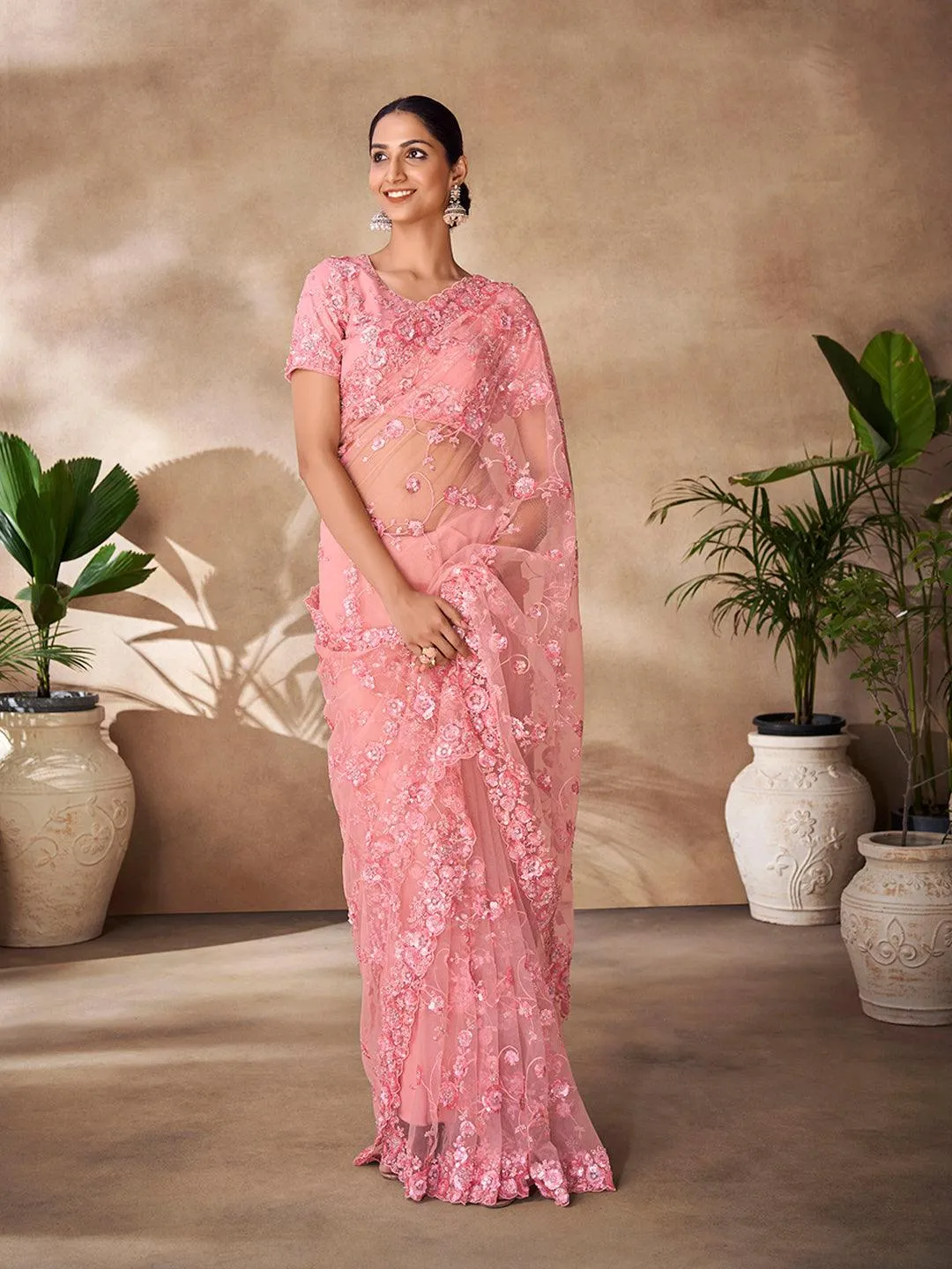 Peach color net base zarkan, thread and embroidered saree