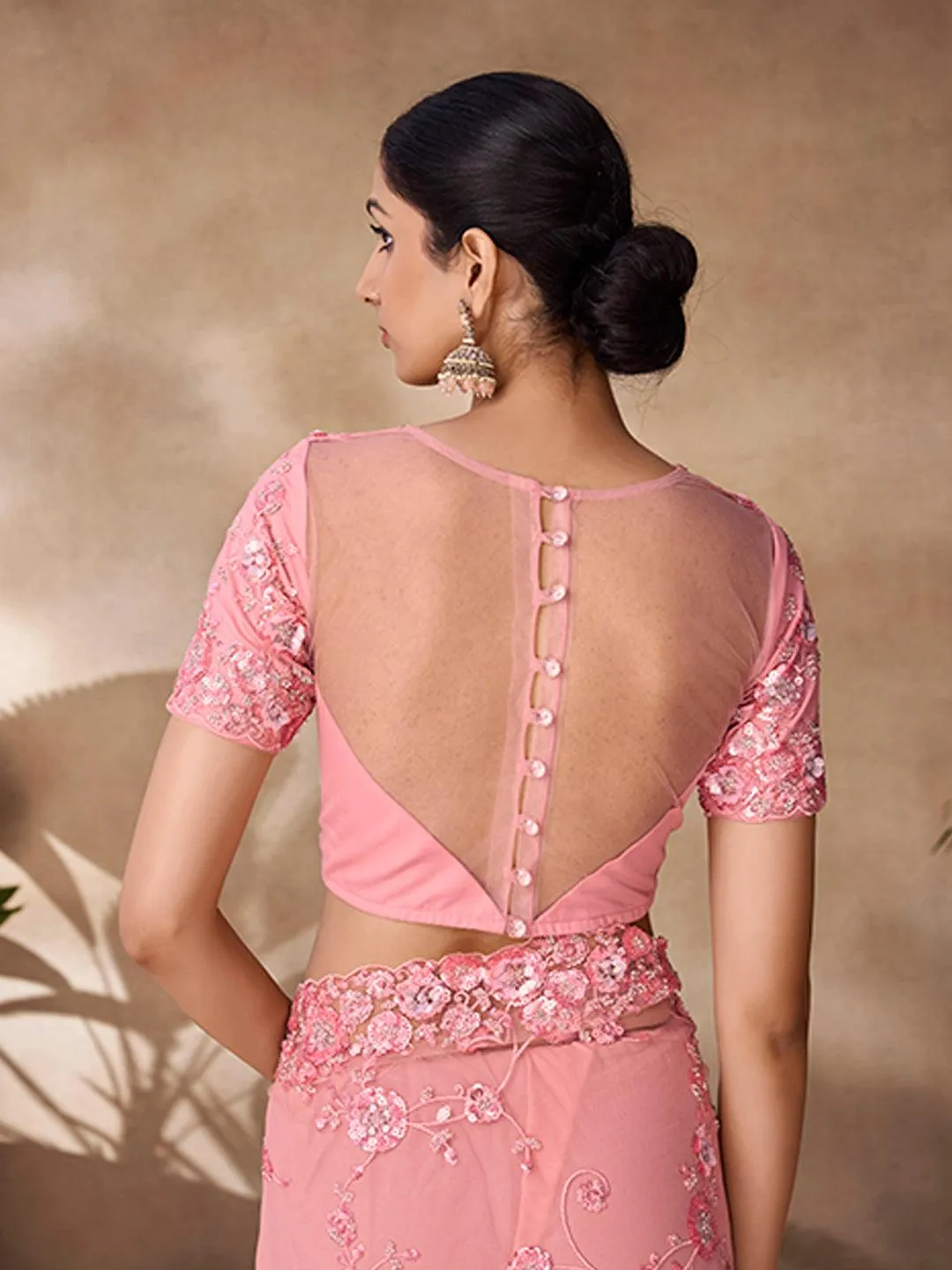 Peach color net base zarkan, thread and embroidered saree