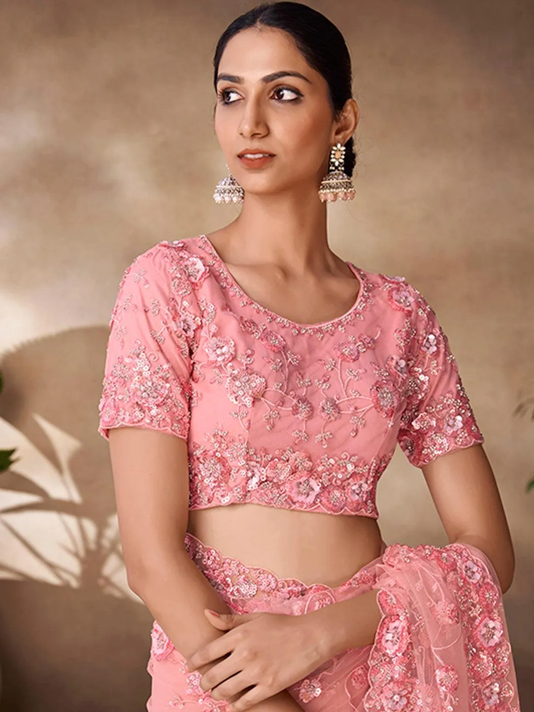 Peach color net base zarkan, thread and embroidered saree
